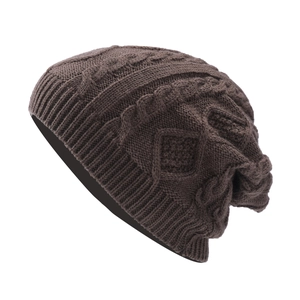 Detailed knit texture of dark brown winter beanie featuring cable and diamond patterns