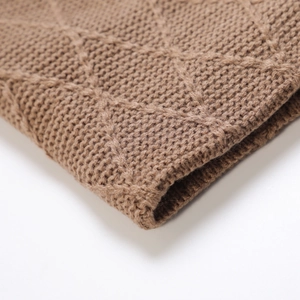 Detailed view of camel cable knit pattern and diamond weave texture on winter hat