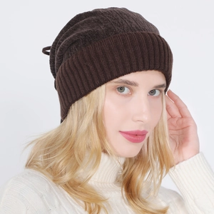 Detail of dark brown knit beanie with thick ribbed texture and fleece lining for winter warmth
