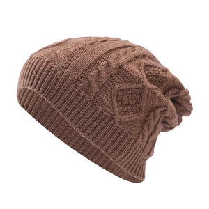 Macro detail of dark brown cable knit pattern and ribbed cuff on winter beanie