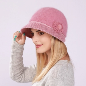 Detailed texture of pink knit rabbit fur bucket hat with plush floral decoration
