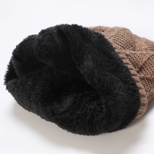 Detailed close-up of dark brown knit beanie with thick black fleece lining for warmth