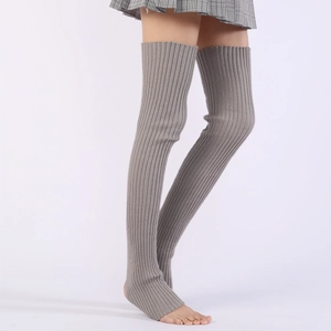 Close-up of grey ribbed knit texture on over-knee yoga leg warmers with stirrup design