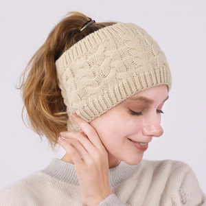 Close-up of cream cable knit headband showing thick texture and warm ear protection