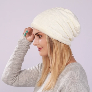 Detailed view of the checkered knit texture and soft plush lining on the cream beanie