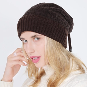 Detail of dark brown knit beanie with soft chenille texture and adjustable drawstring