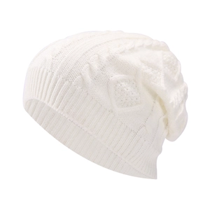 Close-up of the cable-knit texture and ribbed cuff on a white winter beanie hat