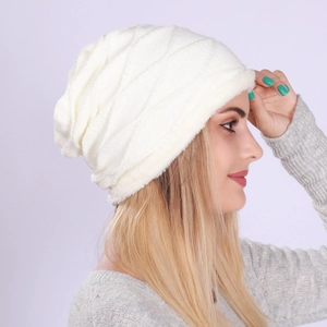 Close-up of white cable knit beanie with thick fleece lining and folded brim detail