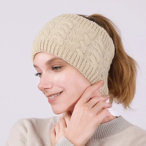 Detailed cable knit texture of the beige winter headband with pony tail hole design
