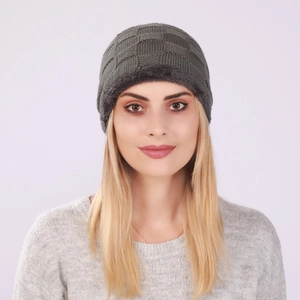 Detail of grey knitted beanie showing checkerboard pattern and warm plush lining