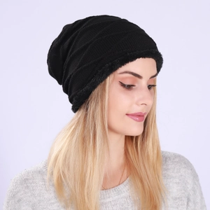 Detail of black winter knit hat featuring warm fleece lining and textured pattern