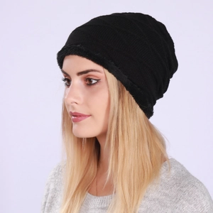Detail of black knitted beanie with thick faux fur lining for winter warmth and comfort