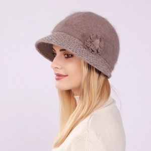 Detail view of pink knit hat featuring plush rabbit fur texture and floral decoration