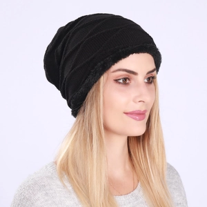 Close-up of black cable-knit beanie featuring thick fleece lining for winter warmth