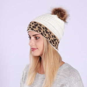Detail of knit beanie with rolled leopard print cuff and fluffy brown faux fur pom-pom