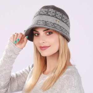 Close-up of gray knit hat featuring wool texture and a gold butterfly decorative buckle
