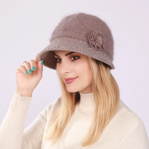 Detail of elegant knit cloche hat with floral accent and soft rabbit fur texture