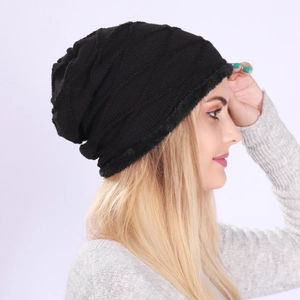 Close-up of black knitted slouchy beanie with warm fleece lining and wave pattern texture