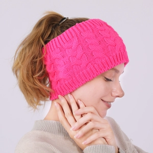 Detail of a bright rose pink cable knit winter headband for women with soft texture