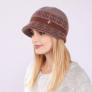 Detailed close-up of a warm knit winter visor hat for women with golden cross ornament