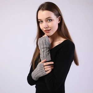 Close-up of grey cable knit fingerless gloves showing detailed texture and wrist length