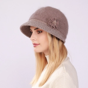 Detail view of a soft knit bucket hat for women with a 3D flower accent and plush texture