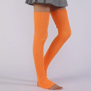 Detail view of bright orange cable knit leg warmers showing ribbed texture and over-knee length