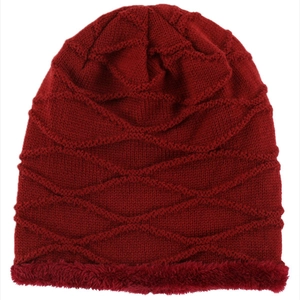 Detail of burgundy knitted beanie with warm fleece lining and wavy stitch texture