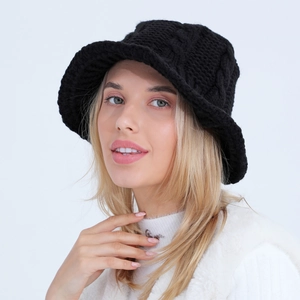 Women's black chunky cable knit bucket hat providing stylish warmth for autumn and winter