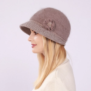 Detail of knit floral decoration and fluffy texture on warm winter hat for women
