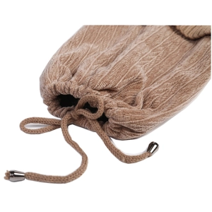 Detail of brown corduroy drawstring cap with soft velvet texture and silver metal tips