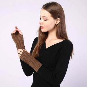 Close-up of brown cable-knit fingerless gloves showing textured warm wool material