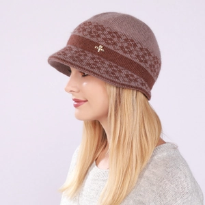 Detail of knitted brimmed beanie featuring golden bee accent and brown floral patterns