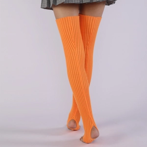 Close-up of bright orange ribbed knit leg warmers with stirrup heel design