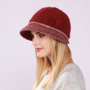 Detail of red knit bucket hat with wool flower decoration and textured brim for women