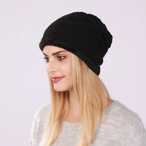 Detail of black winter knit beanie showing thick fleece lining and warm ribbed texture