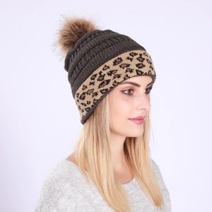 Detail view of winter beanie with thick knit texture and leopard print rolled edge
