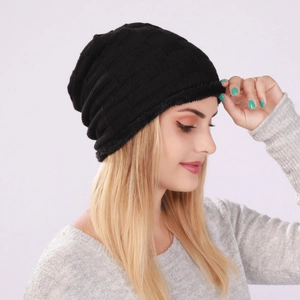 Detail of black checkered knit beanie with warm fleece lining for winter insulation
