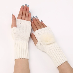 Gants en tricot beige sans doigts avec pompons moelleux et poignets côtelés en gros plan