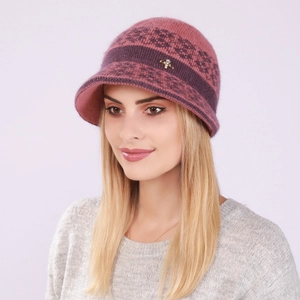 Detail of pink knitted cloche hat with fuzzy texture and elegant gold jewelry pin