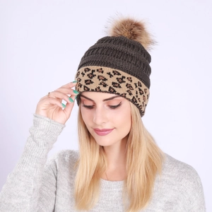 Detail of grey leopard print knitted beanie with a soft brown faux fur pom-pom