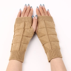 Close-up of khaki knitted fingerless gloves showing diamond pattern and ribbed cuffs