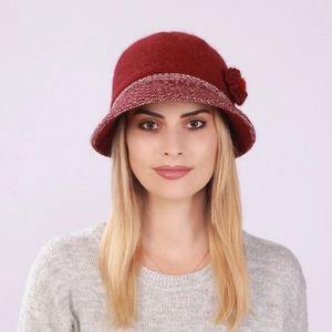 Close-up of wine red knitted bucket hat featuring decorative flower and warm texture