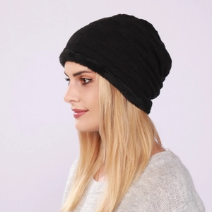 Detail of black knitted beanie featuring checkered texture and warm plush faux fur lining