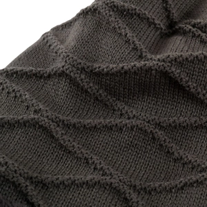 Macro detail of dark grey diamond pattern knit fabric on a thick winter beanie hat