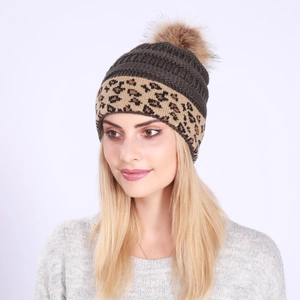 Detailed close-up of a warm winter knit beanie featuring a leopard print cuff and a faux fur pom