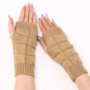 Close-up of camel knitted fingerless gloves showing thick ribbed texture and elastic warm fabric