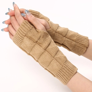 Macro detail of camel knitted fingerless gloves with geometric textured pattern