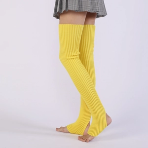 Close-up of bright yellow ribbed knit over-knee leg warmers with stirrup design