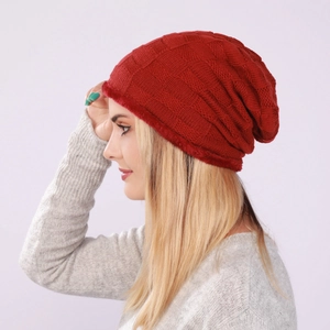 Close-up of dark red knitted beanie featuring checkered pattern and soft faux fur lining
